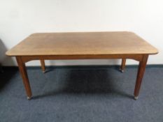 An Edwardian oak table on castors, length 168 cm x width 90 cm.