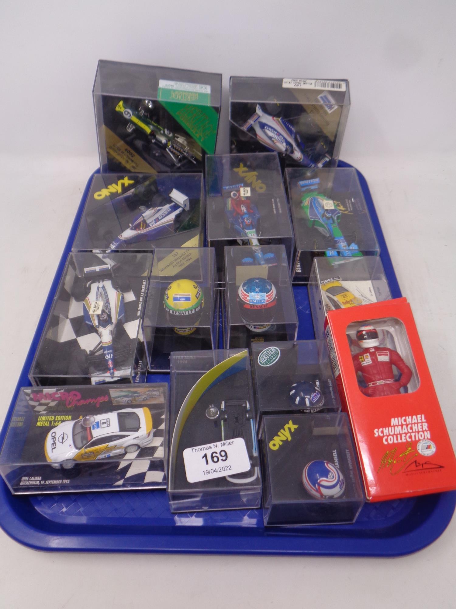 A tray of Onyx Heritage Formula Team Rosberg miniature die cast racing cars and helmets in plastic