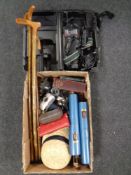 A box of walking sticks, boot stretchers, hats, vintage cameras, books,