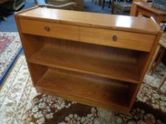 A set of teak bookshelves fitted a drawer