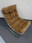 A mid century chrome tubular metal lounge chair in corded fabric