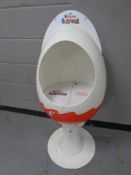 A Kinder Suprise egg shop display stand on pedestal