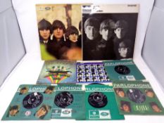 Two Beatles vinyl LP's together with seven Beatles 7 inch singles including Magical Mystery Tour,