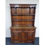 A Titchmarsh and Goodwin carved oak welsh dresser, height 165.