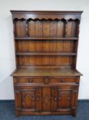 A Titchmarsh and Goodwin carved oak welsh dresser, height 165.