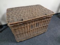 An antique wicker hamper containing a quantity of Christmas decorations