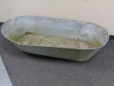 A large galvanised tin bath