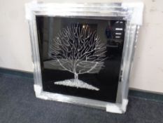 A contemporary mirror framed picture depicting a tree with glitter decoration