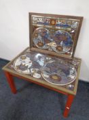 A brass bound mirrored coffee table depicting a map of the world together with a matching wall