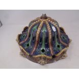 A 19th century Majolica style glazed light shade decorated with lion masks