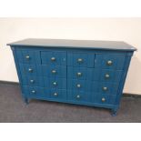 A contemporary ten drawer chest in teal finish