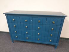 A contemporary ten drawer chest in teal finish