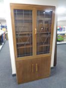 An early twentieth century mahogany double door bookcase fitted with cupboards beneath