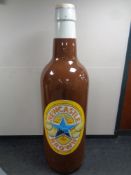 A large plastic Newcastle Brown Ale advertising bottle,