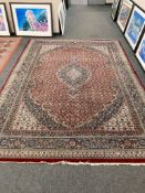 A machine made Persian design carpet 357 cm x 256 cm.