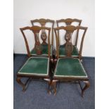 A set of four nineteenth century mahogany dining chairs on cabriole legs