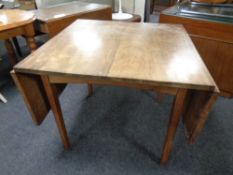 A mahogany flap sided dining table