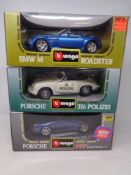 Three Burago 1:18 die cast cars - Porsche 911 Carrera GT, Porsche 356 Polizei and a BMW M Roadster,