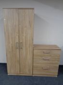 A contemporary double door hanging wardrobe fitted with a shelf and matching three drawer chest