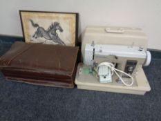 A Newholme electric sewing machine in case together with a vintage leather briefcase and a Japanese