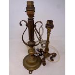 An antique brass ships candlestick together with a further brass railway style lamp
