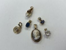 Six 9ct gold pendants, various.