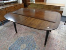 A mid 20th century teak G Plan E Gomme extending dining table with leaf,