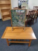 A twentieth century Danish teak coffee table with undershelf together with tapestry fire screen