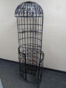 A wrought iron cage cocktail wine rack