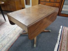 A 19th century mahogany flap sided pedestal dining table
