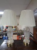 A pair of cut glass table lamps with shades.