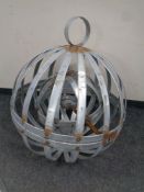 A bespoke metal spherical hanging candle holder