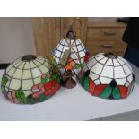 Two leaded glass lamp shades together with further lamp with shade