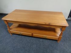 A contemporary two tier coffee table fitted with two drawers