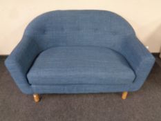 A two seater low backed settee in blue buttoned fabric (af)