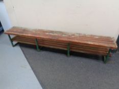 A twentieth century iron wooden slatted bench with shelf,