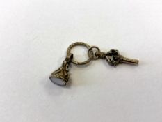 A gold key and fob on ring