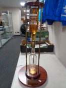 A Bells illuminated hour glass advertising stand