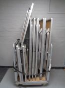 A metal trolley containing ten stainless steel framed banqueting tables
