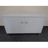 A contemporary double door sideboard in grey finish on raised legs