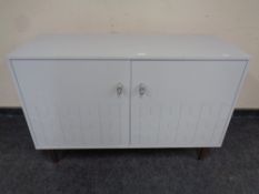A contemporary double door sideboard in grey finish on raised legs