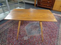 An Ercol solid elm and beech table