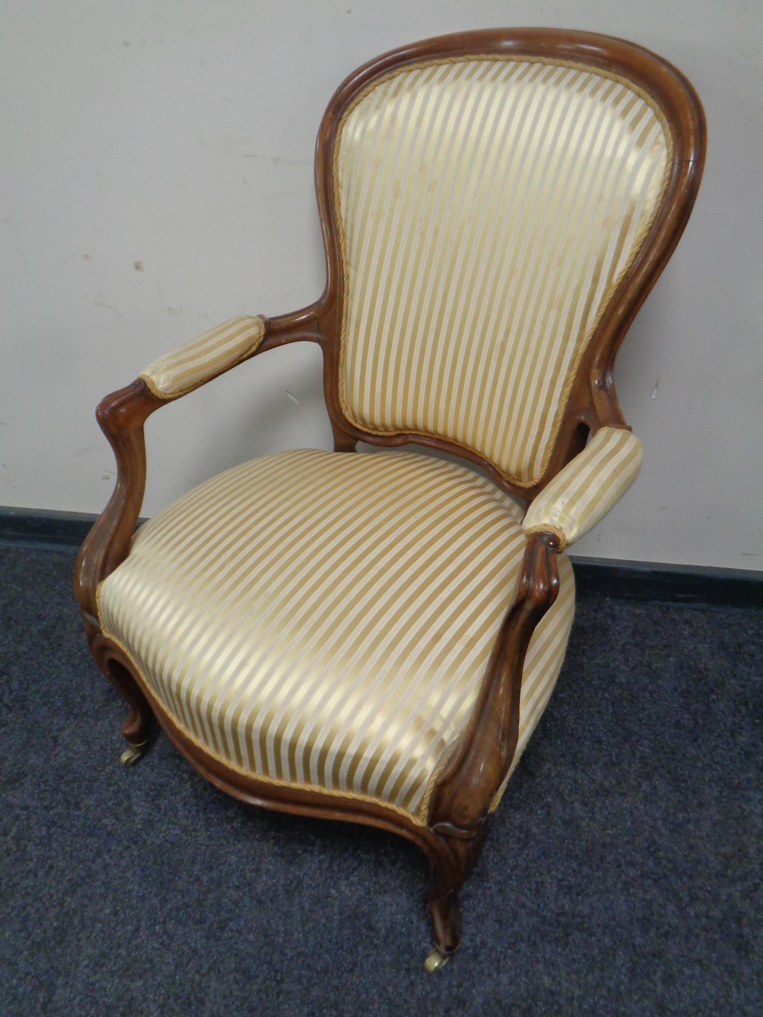 A mahogany framed salon armchair in green striped fabric