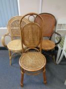 Two bamboo and wicker armchairs together with a further bamboo and wicker dining chair