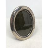 A silver oval photo frame,