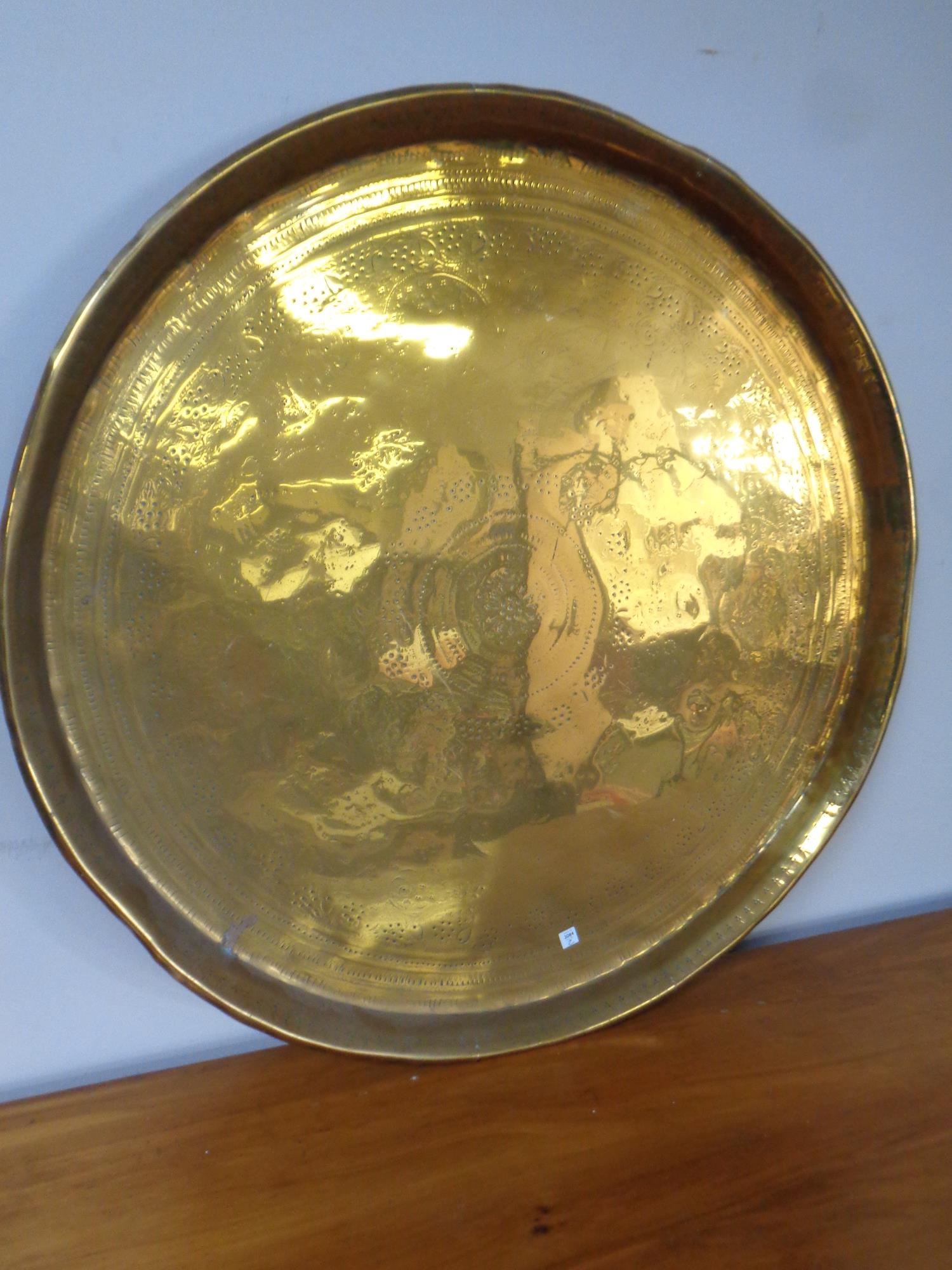 A circular Indian brass tray, diameter 57 cm.