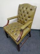 A mahogany framed green buttoned leather desk armchair