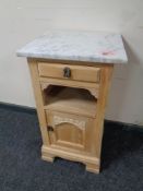 An antique stripped pine marble topped pot cupboard
