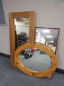 Two chunky pine framed mirrors together with a further teak framed mirror
