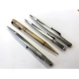 Three silver pencils and one other